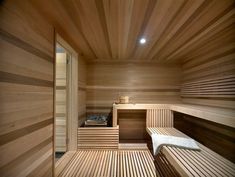 a sauna room with wooden walls and benches