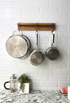 pots and pans are hanging on the wall