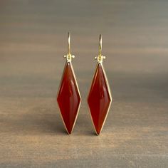 Rich vermillion color balances elegance with extravagance in these strikingly structured carnelians. 18k yellow gold Carnelian, 31.8ctw, 11mm x 38mm (7/16" x 1 1/2")Earrings hang 2 1/16" from the ear Each earring weighs 5.3g Yellow Gold Carnelian Jewelry With Polished Finish, Luxury Carnelian Jewelry For Formal Occasions, Elegant Carnelian Jewelry For Formal Occasions, Gold Carnelian Gemstone Earrings, Elegant Carnelian Dangle Earrings, Elegant Carnelian Earrings, Formal Chalcedony Jewelry With Polished Finish, Formal Orange Gemstone Earrings, Formal Red Carnelian Jewelry