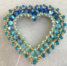 a beaded heart with blue and gold beads