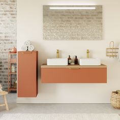 a bathroom with two sinks and a towel rack on the wall next to an orange cabinet