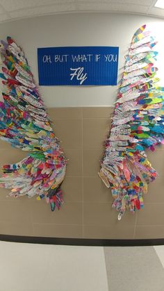 an office cubicle decorated with colorful paper angel wings