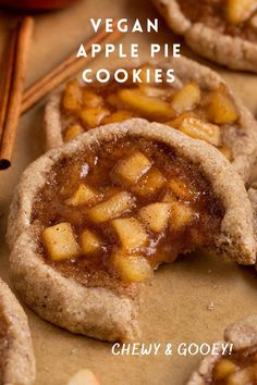 vegan apple pie cookies on a baking sheet with cinnamon sticks