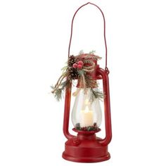 a red lantern with a lit candle in it and pine cones hanging from the top