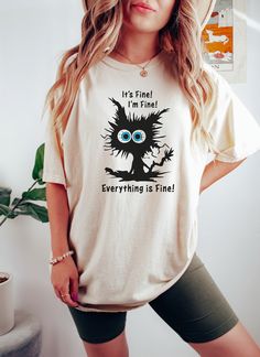 "It's Fine I'm Fine Everything Is Fine Shirt, I'm Fine Shirt, Cat Tee, Sarcasm Shirt, Gift for Funny Friends, Positivity Shirt, Mental Shirt 🌺 How To Order 🌺 1-) Please, check and review all the photos. 2-) Choose your t-shirt size and color. 3-) Click add to cart. You can go back to add more shirts. 4-)Click \"Proceed to check out\". 5-)When you check out, you can add a note to seller for any request. 🌺Unisex Shirts🌺 🌻 Unisex t shirt fits like a well-loved favorite, featuring a crew neck, short sleeves and designed with superior airlume combed and ring-spun cotton that acts as the best blank canvas for printing. 🌺Youth Shirts 🌺 🌻 This youth tee fits like a well-loved favorite, featuring a crew neck, short sleeves and superior airlume combed and ring-spun cotton that acts as a blan Cat Shirts For Women, Sarcasm Shirts, Funny Friends, Im Fine, Cute Black Cat, T Shirt Fits, Cat Sweater, Positive Shirt, Its Fine