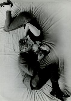 a man and woman laying on top of each other