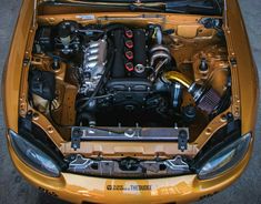 the engine compartment of a yellow sports car