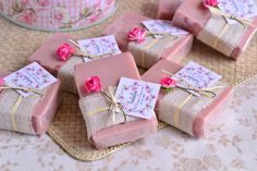 pink soap wrapped in burlap with flowers on top and tags attached to them