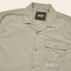 Our new Forager Utility Shirt takes cues from Japanese outdoor gear we've been admiring for years. Vintage styling combines swimmingly with tonal buttons and tough nylon fabric for a sleek, layerable tech shirt that will let you forage with ample storage. The Forager’s range includes hiking trails, bars and urban jungles all over the globe. 100% lightweight nylon taslan Snap closure left chest pocket with side entry mesh secondary pocket Mesh lined vented back yoke Mesh zippered stash pocket at Khaki Button-up Top For Outdoor, Khaki Collared Camp Shirt For Outdoors, Collared Solid Shirt For Outdoor, Solid Collared Shirt For Outdoor, Solid Camp Shirt For Summer Outdoor, Solid Summer Camp Shirt For Outdoor, Summer Solid Camp Shirt For Outdoor, Spring Khaki Outdoor Shirt, Spring Outdoor Khaki Shirt