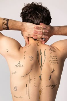 a man with many tattoos on his back