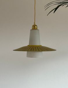 a white and gold light hanging from a ceiling