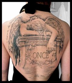 a woman with an angel tattoo on her back