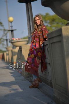 "This beautiful full body Mexican poncho is handmade by Cross Stitch both in the front and in the back. The colorful floral design will add style to your wardrobe and keep you warm too! One size fits all: From extra small to 2x It measures 47\" Long and 31.5\" wide" Bohemian Red Shawl Cape, Red Bohemian Poncho Cape, Red Folk Style Poncho For Fall, Red Cape Poncho For Festival, Red Bohemian Cape Poncho, Red Bohemian Shawl Cape, Bohemian Red Cape For Festivals, Multicolor Fall Festival Kaftan, Red Long Sleeve Poncho For Festival