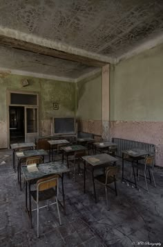 an empty room with tables and chairs in it