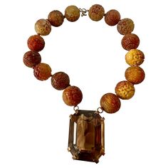 THIS IS A SPECTACULAR AND RARE ANTIQUE 750 CARAT SMOKY TOPAZ AND LARGE CARVED JADE BEAD PENDANT NECKLACE FROM THE ESTATE OF HOLLYWOOD ACTRESS MARY LOU DAVES WITH AN ABSOLUTELY EXTRAORDINARY MONUMENTAL EMERALD CUT 750 CARAT SMOKY QUARTZ. THE SMOKY TOPAZ HAS INCREDIBLE COLOR AND CLARITY AND IS A MAGNIFICENT GEM. THE GEM IS 62MM (2.5 INCHES) LONG, 47MM WIDE AND 39MM DEEP. THE GEM IS SET IN GILT STERLING SILVER AND HANGS FROM A MAGNIFICENT CHAIN OF LARGE CARVED NATURAL JADE BEADS. THE JADE BEADS ARE Antique Carved Jade Pendant And Beaded Necklace, Bead Pendant Necklace, An Affair To Remember, Case 39, Smoky Topaz, Carved Jade, Topaz Necklace, Bead Pendant, Beaded Pendant Necklace