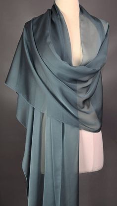 This scarf is iridescent elegance and is definitely a muted blue. Monitor may reflect the scarf brighter than what it actually is.  Perfect for all seasons.  Dress it up or dress it down.  The choice is yours.  All of my scarves can be dressed up or down. I finish my scarves with a machine rolled hem.  I am constantly looking for unusual fabrics that would make wonderful scarves. Be nice to your scarves and they will last a long, long time. Enjoy the scarf and wear it with confidence.  Polyester Elegant Blue Scarves For Wedding, Elegant Blue Scarf For Wedding, Elegant Blue Shawl Scarves, Elegant Blue Silk Shawl Scarf, Elegant Blue Silk Scarf For Wedding, Elegant Blue Scarves For Party, Elegant Blue Silk Scarf For Formal Occasions, Elegant Blue Silk Scarf For Evening, Ladies Gifts