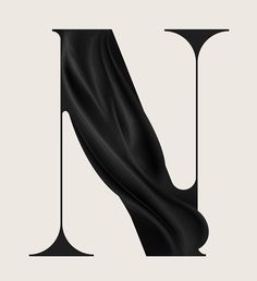 the letter n is made up of black fabric and it looks like an art piece