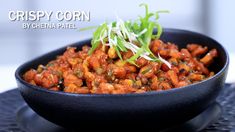 crispy corn by cheeta patel in a black bowl on a blue plate