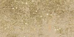 gold glitter textured paper with white stars on the bottom and light brown ground behind it