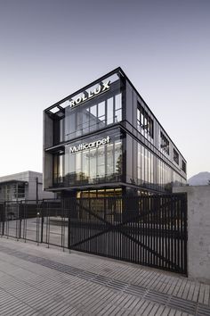 a black and white building with the word rolex on it's front entrance