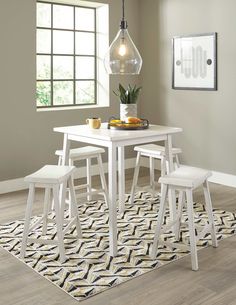 a white table and chairs in a room