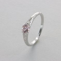 These is a beautiful Sterling Silver Ring with a simulated Morganite. The ring is made out of solid 925 Silver and there is no nickel or other substances causing most allergies. This makes the ring hypo allergenic. The silver on ring is finished with a layer of Rhodium to make the ring less tarnish. Size of the Stone 0.5 x 0.5 cm or  0.20 x 0.20 inch Please note: Our jewelry is photographed close up to show detail and may appear larger than they are. We use a dime coin as size reference on one of the pictures. You will receive the item in a gift box - perfect to surprise someone or yourself. Usually we ship on the same day we receive the payment for the order. We want you to be happy with your purchase. If you do not like what you bough can send it back and we will refund you the money. Pl Silver Birthstone Ring In 14k White Gold For Gift, Wedding Rose Gold Birthstone Ring In Sterling Silver, Delicate Sterling Silver Rings For Formal Occasions, Delicate Silver Solitaire Wedding Ring, Delicate Silver Ring With Round Cut, Delicate Silver Round Cut Ring, Delicate Silver Rings For Formal Occasions, Elegant Pink Birthstone Ring In Sterling Silver, Elegant Pink Sterling Silver Birthstone Ring