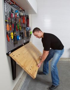 a man working on a workbench with tools