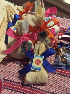 a bunch of items that are sitting on a table together with ribbons and tags attached to them