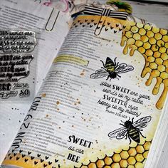 an open bible with bees on it