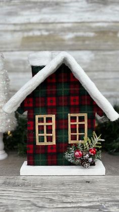 a small house with a christmas decoration on the roof