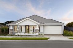 a white house with two garages on the street