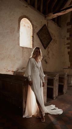 a woman is standing in an old church