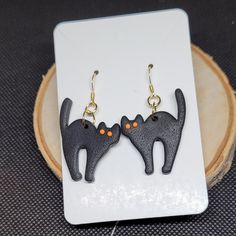 Black cat earrings Halloween themed earrings animal jewelry Handmade earrings from sculpey souffle polymer clay, lightweight. Hardware consists of 18K gold-plated 304 stainless steel ear wires and gold plated jump rings. Dimensions: Drop length- 1.65 inches Length- 1.40 inches Width- 1 inch FREE shipping on all Canadian orders. Sent as oversized letter mail with no insurance or tracking information.  **I am not responsible for lost, damaged or undelivered mail ** Cute Black Pierced Jewelry, Hypoallergenic Cat Ears Jewelry For Gift, Handmade Cat Ears Jewelry For Gift, Black Cat Ears Jewelry As A Gift, Handmade Cat Ears Jewelry For Gifts, Adjustable Cat Ears Earrings As Gift, Novelty Black Earrings For Gift, Black Novelty Earrings For Gifts, Black Novelty Earrings For Gift