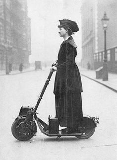 an old photo of a woman on a scooter in the middle of the street