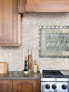 a stove top oven sitting inside of a kitchen next to wooden cupboards and counter tops