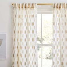 the curtains are hanging on the window sill in front of an open window with white and brown polka dots