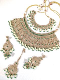 A semi-Indian bridal set is a stunning and elegant jewelry ensemble that beautifully combines elements of traditional Indian craftsmanship with modern design sensibilities. This exquisite set is designed for brides who wish to strike a perfect balance between traditional and contemporary aesthetics on their special day. The semi-Indian bridal set typically includes a harmonious combination of statement necklaces, earrings, tikka, and jummar all carefully crafted with intricate detailing and luxurious materials. These pieces enhance the bride's beauty and complement her wedding attire, whether a saree, lehenga or any other traditional outfit. One of the key features of this bridal set is its versatility. It effortlessly melds the opulence of Indian jewelry with more understated, modern elem Bride Style, Indian Bridal, Elegant Jewelry, Bridal Sets, Wedding Attire, Indian Jewelry, Traditional Outfits, Semi Precious Gemstones, Jewelry Set