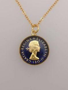 1960 Sixpence NecklaceA genuine coin has been used.The coin has been polished and gold plated.It has then been hand enamelled on both sides in blue. Chain is 18" and gold plated.The pendant comes in a presentation box with a certificate of authentication.Years between 1953-1967 can be made but will take a few weeks if not in stock. Please message us for availability. Vintage Coin Necklace For Formal Occasions, Vintage Coin Necklaces For Formal Occasions, Gold Vintage Coin Necklace For Gift, Royal Gold Jewelry For Formal Occasions, Vintage Gold Coin Necklace For Gift, Gold Coin Necklace Collectible, Vintage Gold Plated Coin Necklace As Gift, Royal Gold Jewelry Gift, Royal Gold Jewelry For Gift