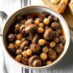 a bowl filled with mushrooms and some bread