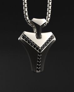 This magnificent pendant is composed of 18k white gold, includes 16 black diamonds and is completely handmade. A talisman stone is for those who want to know what life is all about. It will bring out all of your great qualities. The vertebrae that make up the human spine influenced its design. On a psychological level, this diamond represents what gives man the fortitude, bravery, drive, and unwavering belief to achieve his goals.Many people like white gold because of its silvery white hue, which gives it a refined appearance while also making it considerably more expensive than silver.White gold is impervious to rust, tarnish, and corrosion. White gold is more durable than yellow gold because it is alloyed with a combination of harder metals. Made entirely by hand with all the love and ar Sterling Silver Black Diamond Pendant Necklace, Luxury White Gold Jewelry With Black Spinel, Sterling Silver Pendant Necklace With Black Diamonds, Luxury Black Spinel Jewelry With Polished Finish, Luxury Black Diamond Pendant Necklace, Luxury Silver Jewelry With Black Diamonds, Modern Sterling Silver Jewelry With Black Diamonds, Luxury Black Spinel Silver Jewelry, Black Diamond Pendant