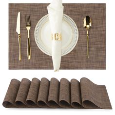 a place setting with napkins, silverware and gold - plated utensils