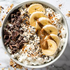 a bowl filled with oatmeal topped with bananas and chocolate