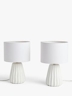 two white lamps sitting next to each other