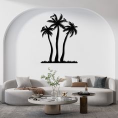 a living room filled with furniture and a palm tree wall decal on the wall