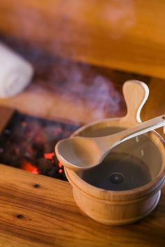 two wooden spoons sitting on top of a bowl next to a fire placemat