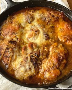 a skillet filled with meat and cheese covered in sauce