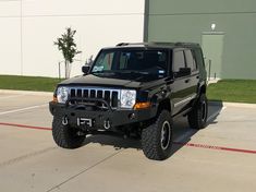 a black jeep parked in front of a building