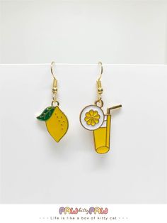 🍋 When life gives you lemons, wear them! Our 'When Life Gives You Lemons' Earrings are the zesty pick-me-up you need. These cute lemon earrings are the perfect splash of fun for any outfit, whether you're strutting your stuff in the summer sun or lounging with a tall glass of lemonade. Made for those who love fruit earrings with a playful twist, they're more than just jewelry--they're a mood! 🍋 🌸✨ Specification ✨🌸 * 18k Gold Plated Earrings * Enamel Charms These quirky pieces also make the u Quirky Yellow Jewelry For Gift, Fun Lemonade, Yellow Funky Earrings For Gift, Cute Fruit Design Earrings, Summer Fruit Design Drop Earrings, Lemon Slice Earrings, Lemon Earrings, Fruit Earrings, Get Well Gifts