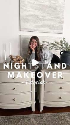 a woman sitting on top of a white dresser