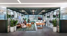 an office with lots of bookshelves and plants